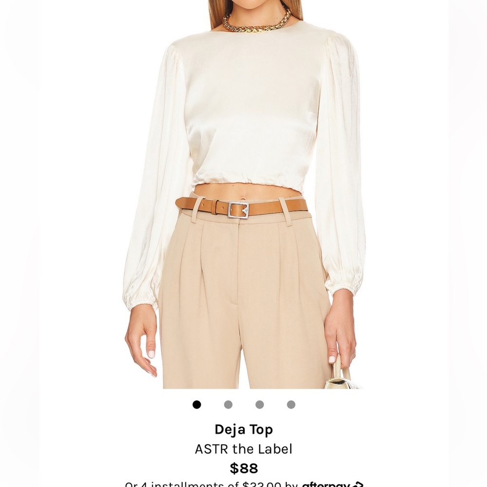 Pearl colored blouse with slightly puffed sleeves and back twist detail